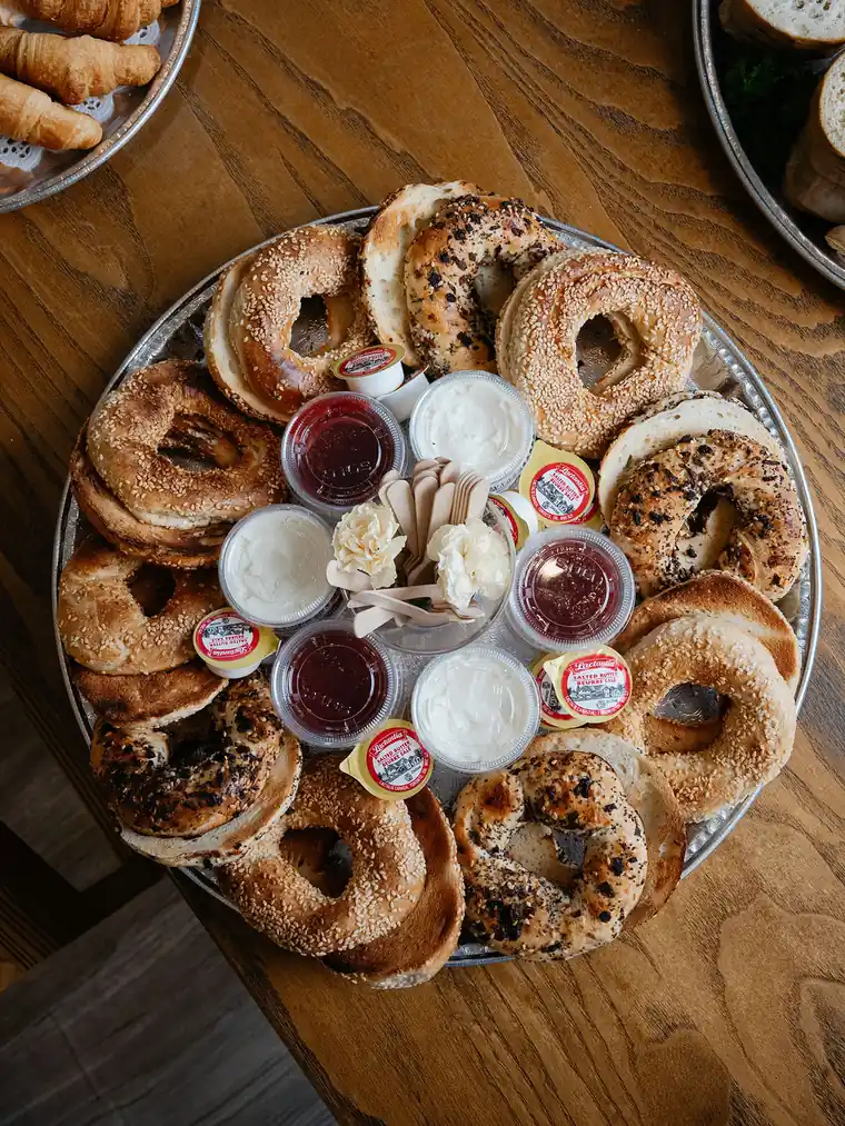 Catering bagel platter with sesame and everything bagels, cream cheese, jam and butter cups