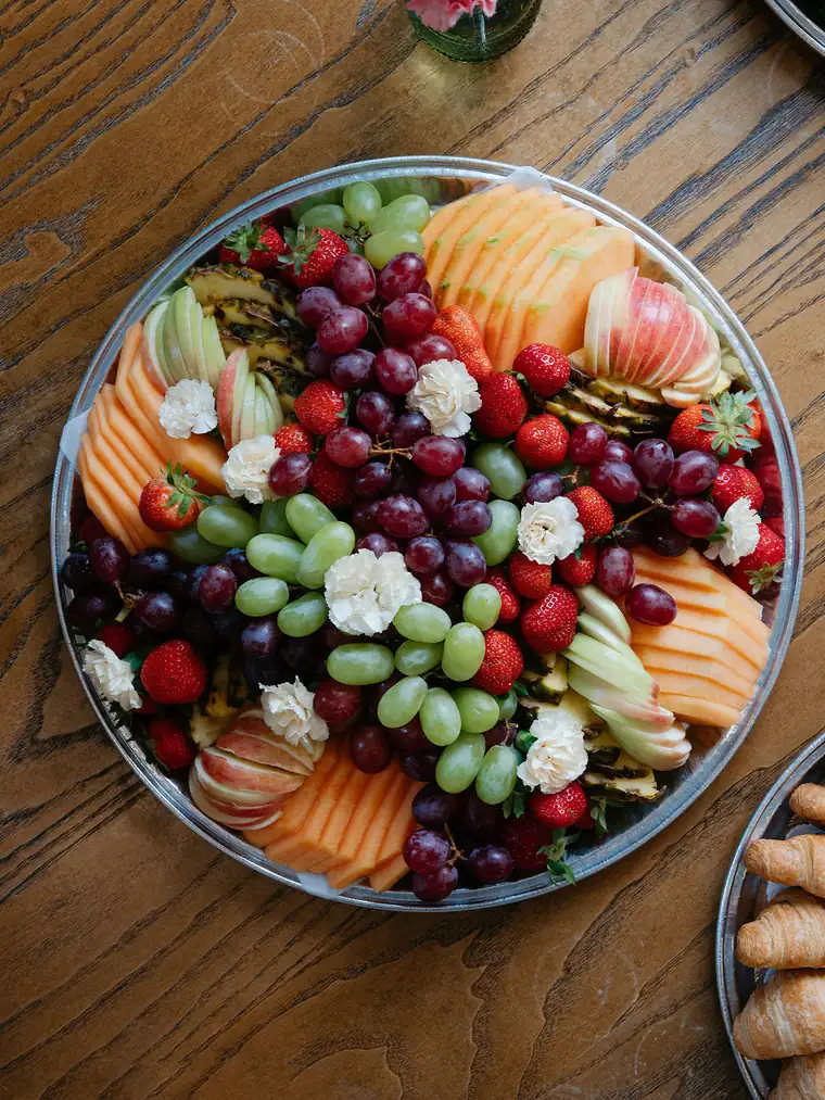 Fresh fruit catering platter with strawberries, grapes, cantaloupe, pineapple and sliced apple